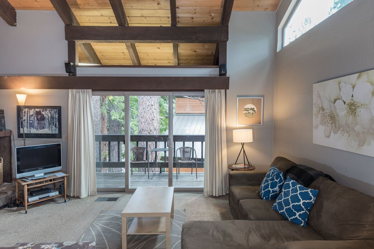 nice living room with wood burning fireplace, cathedral ceilings