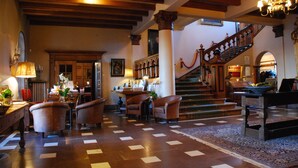 A spacious lobby with a grand staircase, wooden flooring, and classic furnishings. - Engsholms Slott - Adults Only (Morko)