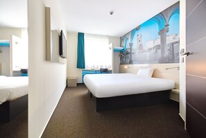 Relax in a stylish room with a large bed, flat-screen TV, and city view.