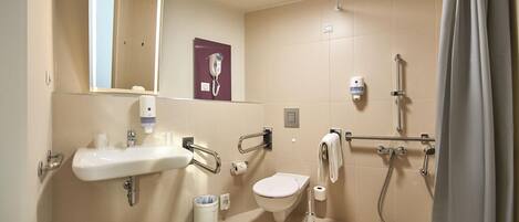 A modern bathroom with a sink, toilet, and shower.
