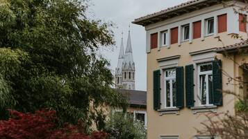 A building with a tower and green shutters.