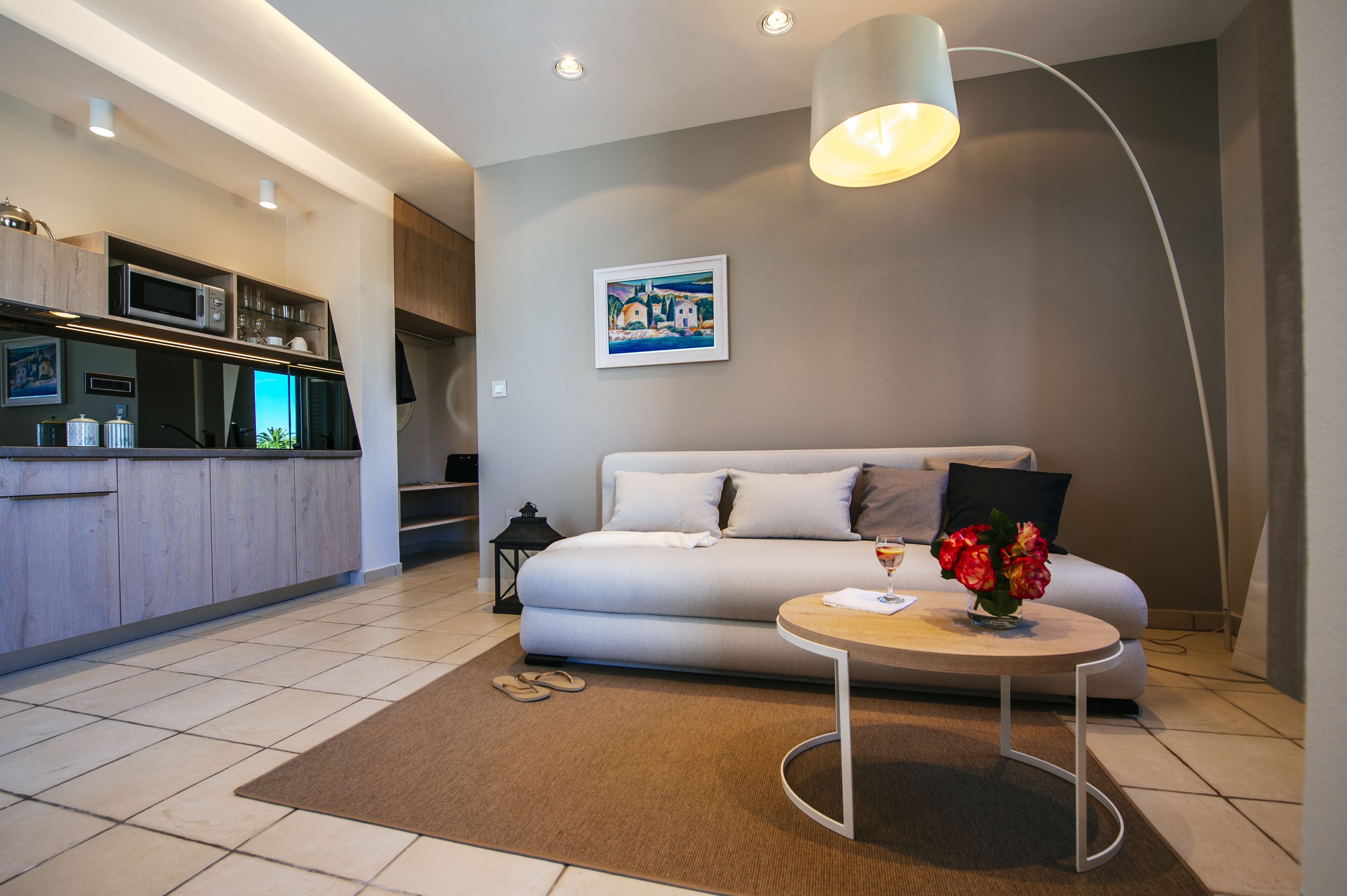 Una sala de estar moderna con un sofá, una mesa de centro y una cocina al fondo.