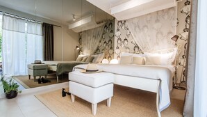 A modern bedroom with a large bed, a nightstand, a mirror, and a potted plant.