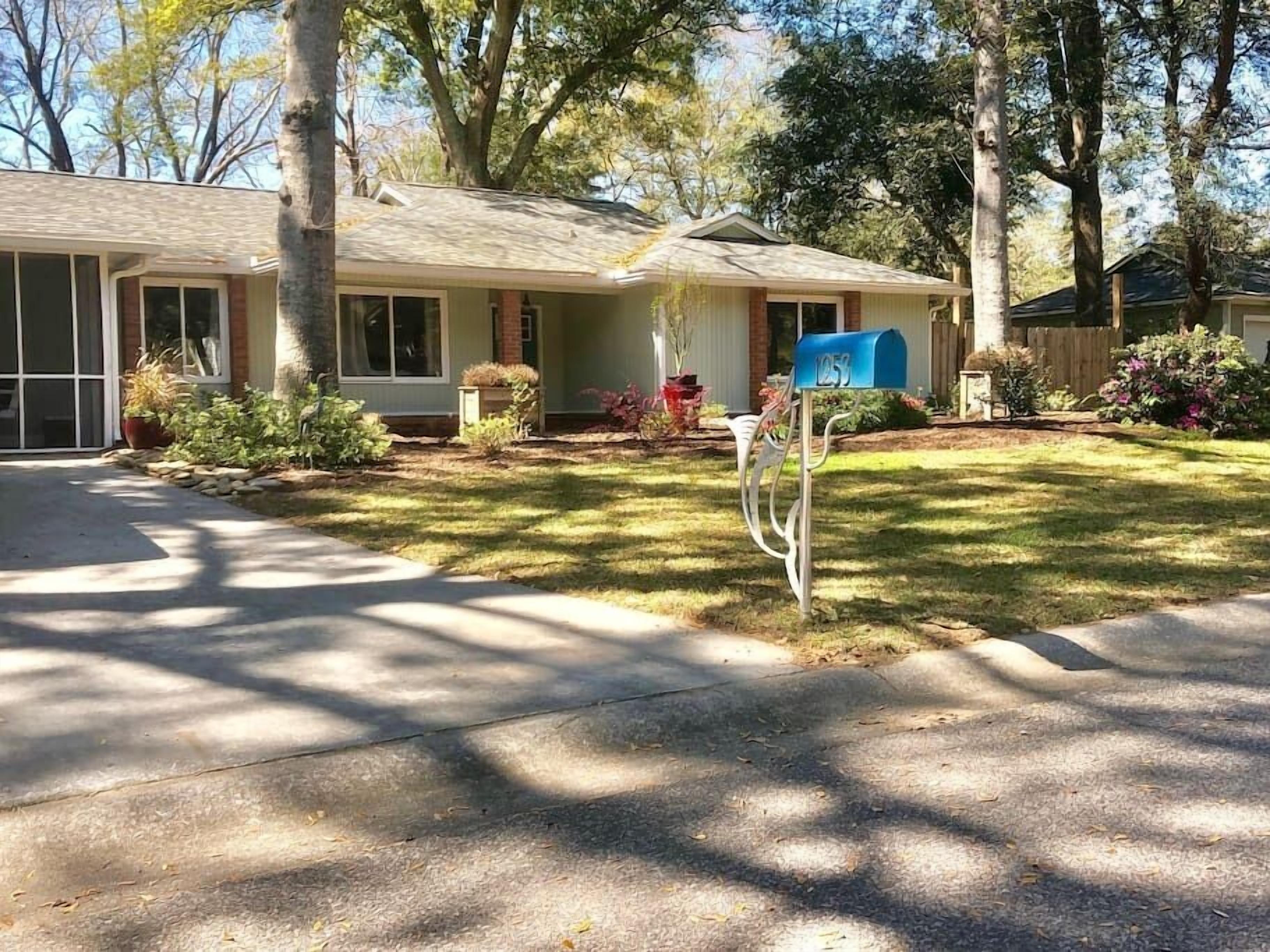 A single-story house with a front porch, a mailbox, and a well-maintained lawn.