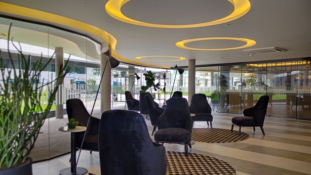 A modern lobby with black chairs, circular ceiling lights, and large windows. - SLAVIERO Campina Grande (Campina Grande)