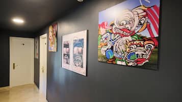 A hallway with three framed artworks on the wall.