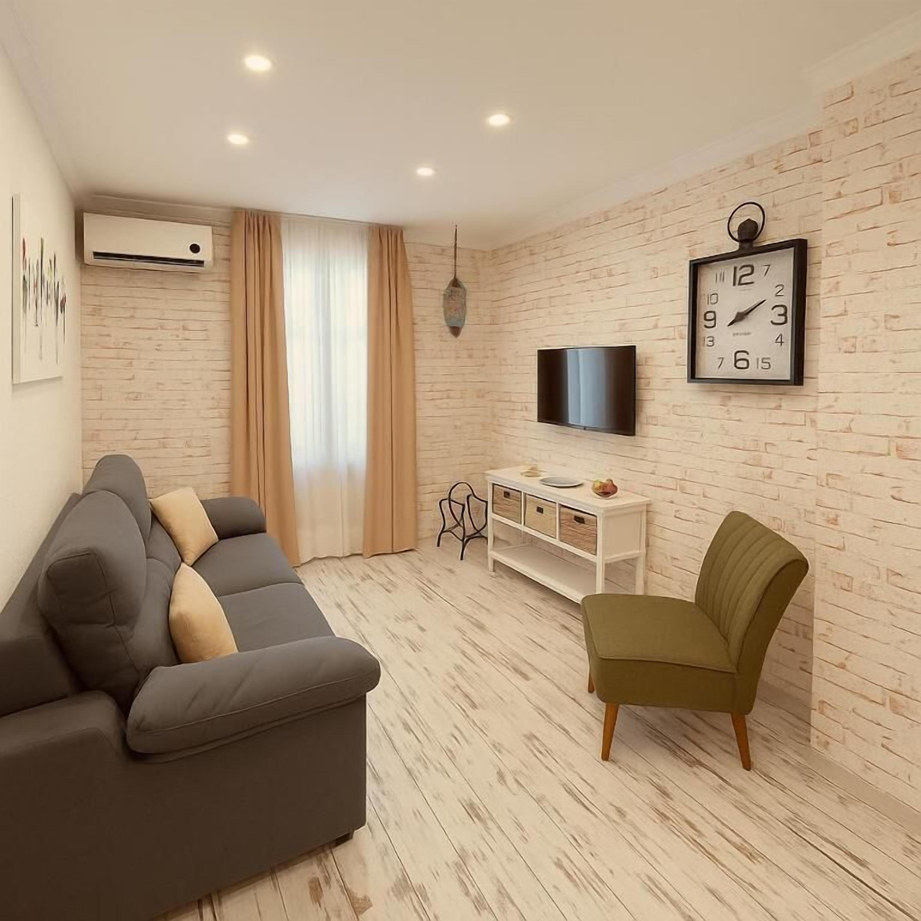 Appartement Deluxe, patio, vue jardin (Ground Floor) | Coin séjour | Télévision à écran plat