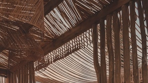 An outdoor dining area with a view of the sunset, wooden pergola, wicker furniture, and various dining accessories. - Kalia Beach Hotel Side  (Manavgat)