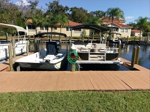 Moored at the marina, a small boat offers a covered seating area.