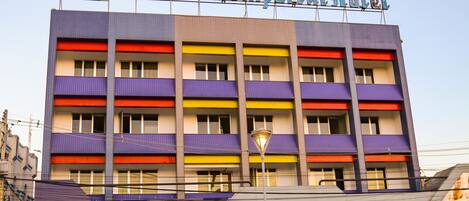 The exterior of the Antonius Imperial Hotel with a colorful facade and multiple balconies.