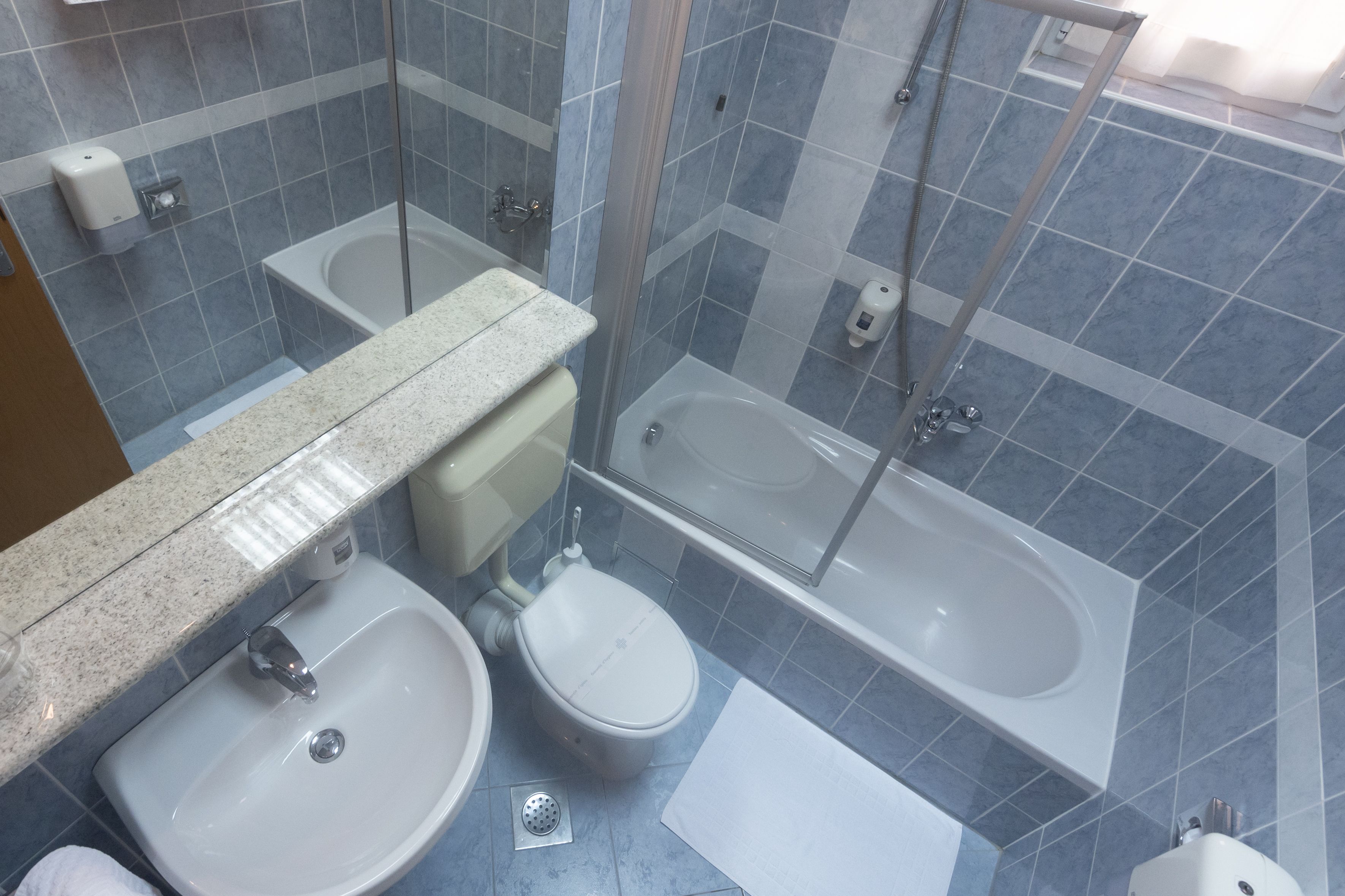 A bathroom with a sink, toilet, and bathtub.