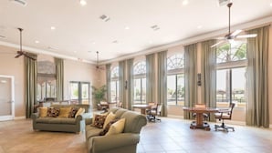 A spacious living area with two sofas, a dining table, and chairs.
