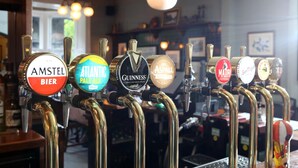 A row of beer taps with labels including Amstel Bier, Atlantic Pale Ale, Guinness, and others. - Pont Y Pair Inn (Betws-Y-Coed)
