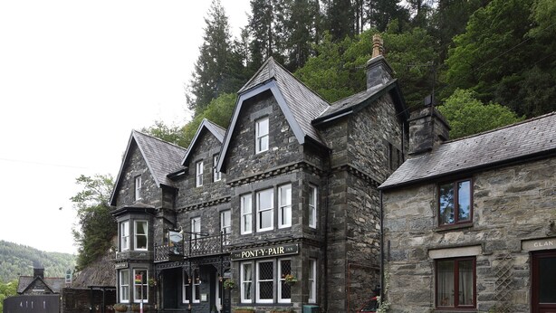 A stone building with a sign reading "The Pont-Y-Pair Inn". - Pont Y Pair Inn (Betws-Y-Coed)