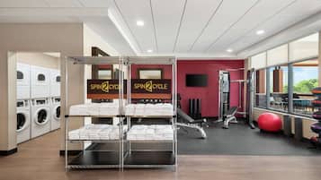 A gym with a spin cycle area, exercise equipment, and a view of the outdoors.