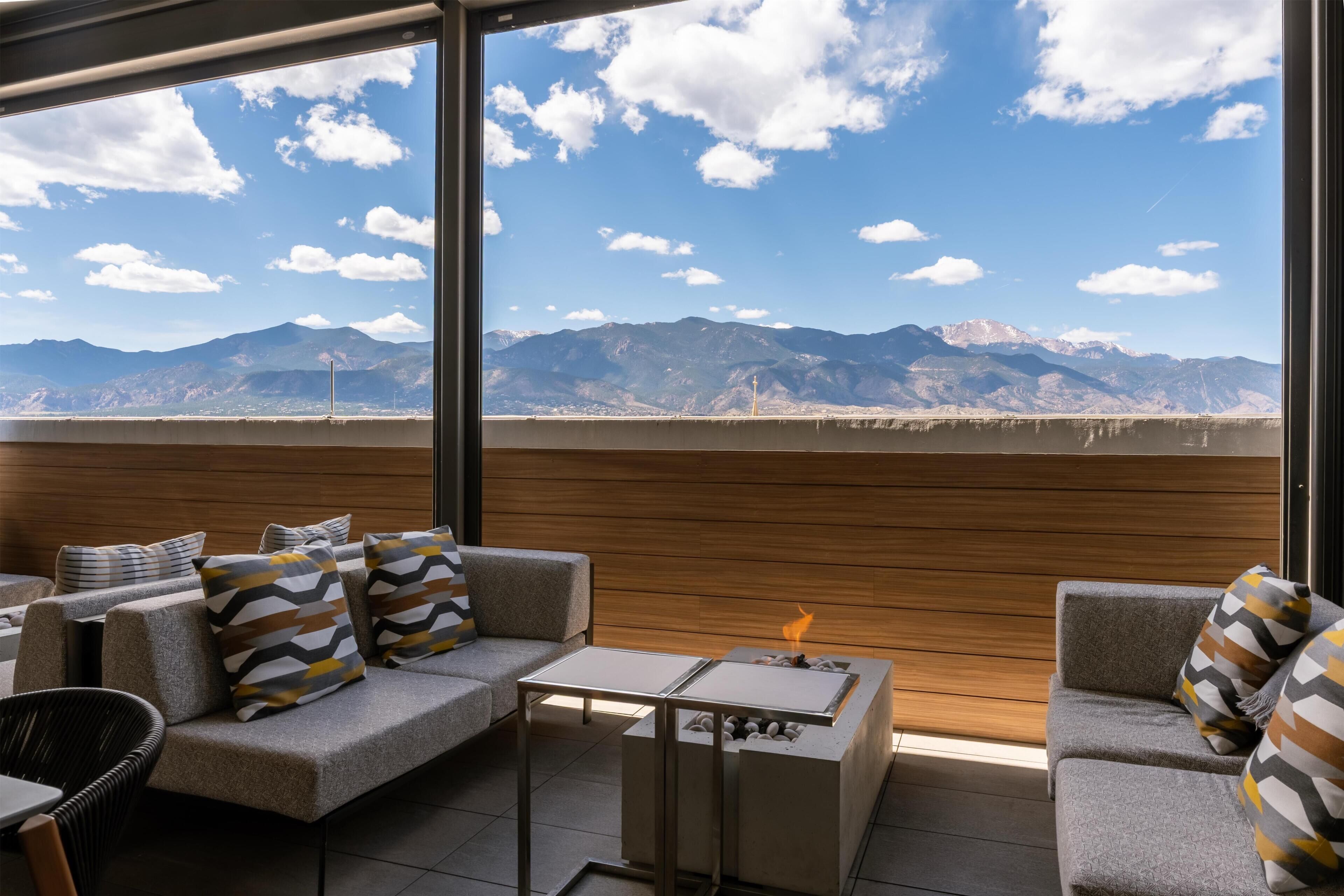 A modern outdoor seating area with a view of mountains.