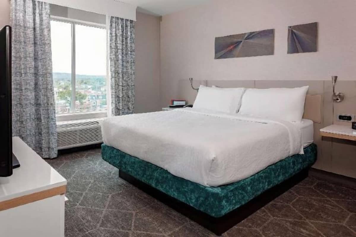 Premium bedding, desk, laptop workspace, blackout curtains