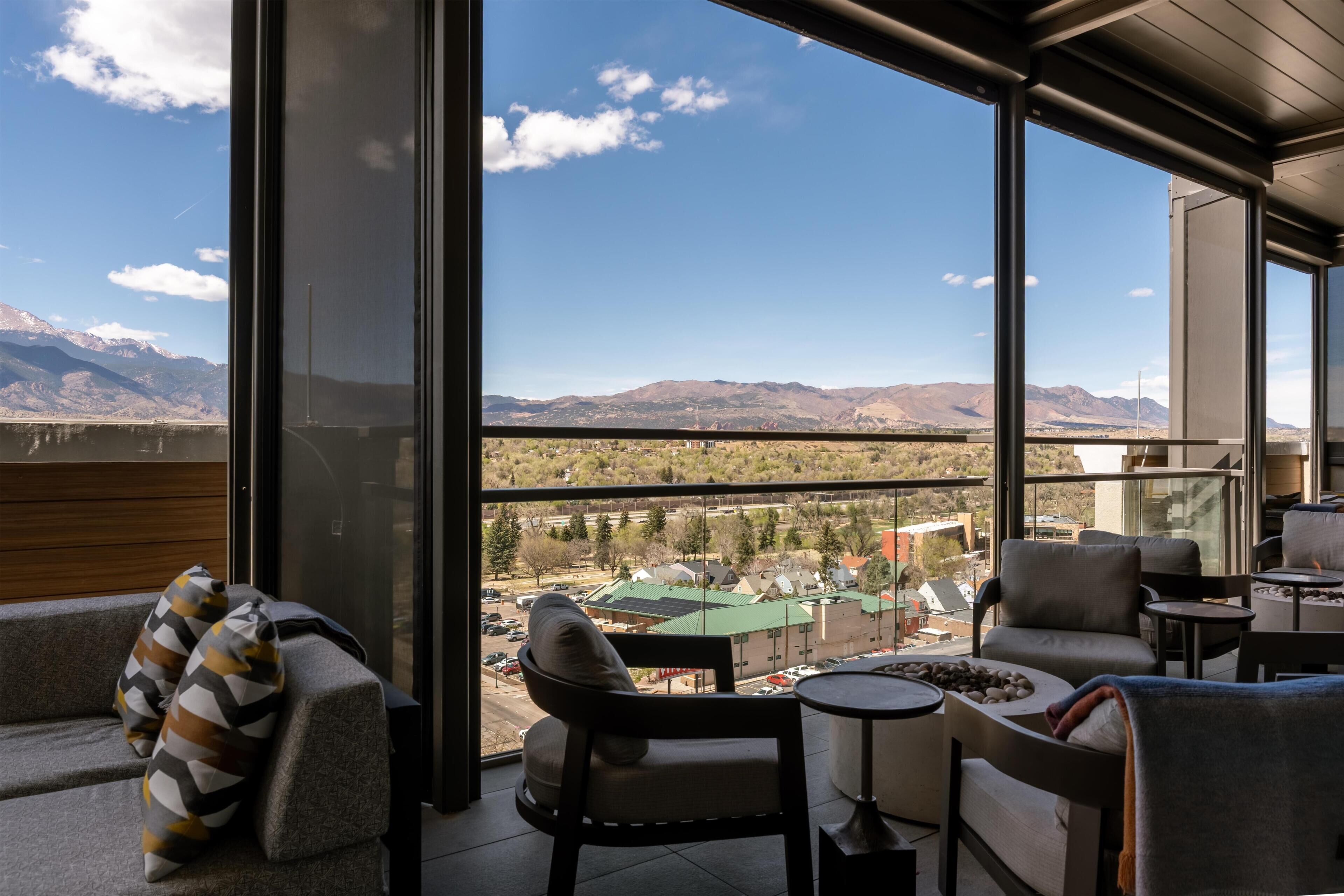 A modern interior with a large window offering a mountain view.