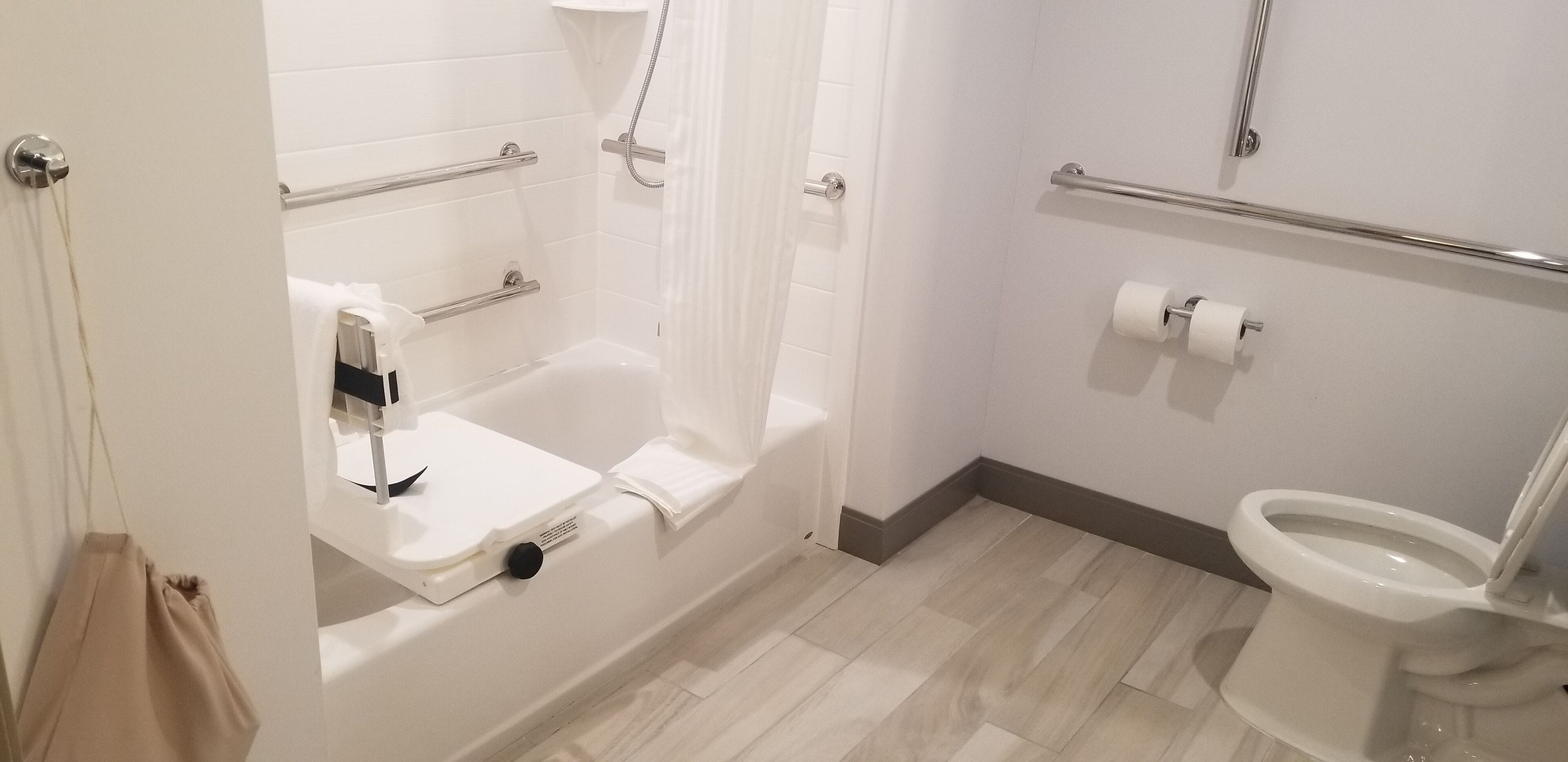 A bathroom with a bathtub, toilet, and shower.