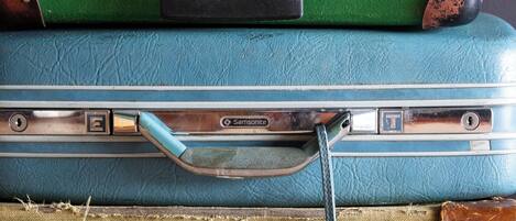 A stack of vintage suitcases with metal clasps and leather straps.