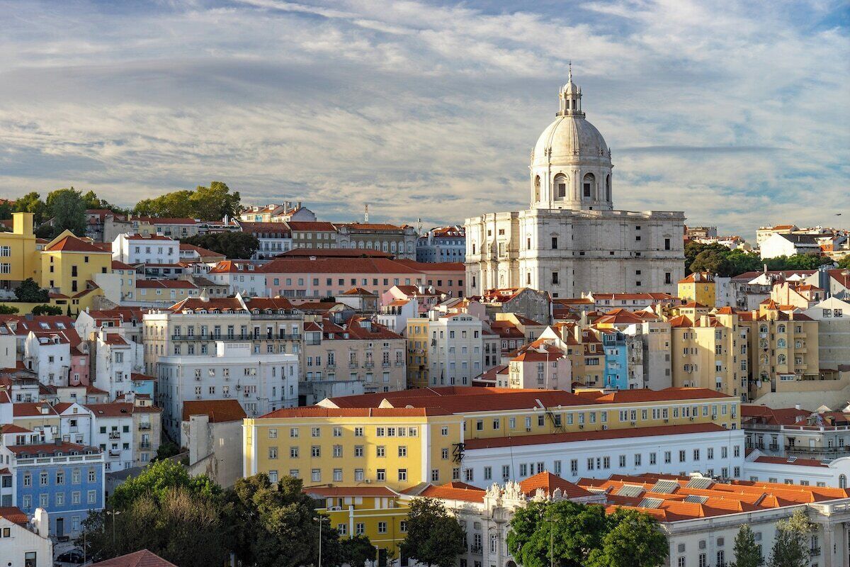 A cityscape with historic buildings, a prominent dome structure, and a dense urban layout.