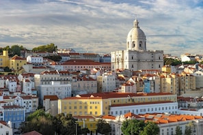 A cityscape with historic buildings, a prominent dome structure, and a dense urban layout.