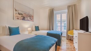 A hotel room with two beds, a desk, a chair, and a TV. - Lisbon City Stay Largo do Carmo (Lisbon)