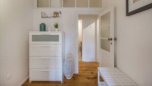 A narrow hallway with a white dresser, a white radiator, and a door leading to another room. - Lisbon City Stay Largo do Carmo (Lisbon)