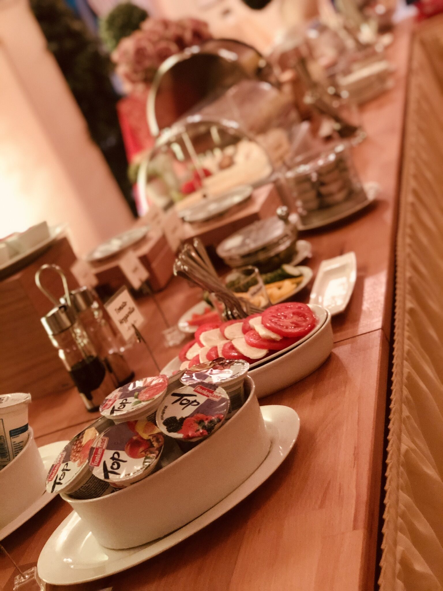 A buffet table with various food items and condiments.