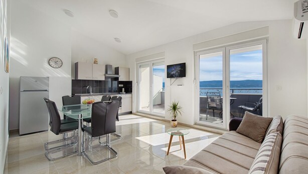 A modern apartment with a kitchen, dining area, and living room with a balcony. - Cezar Luxury Apartments (Omis)