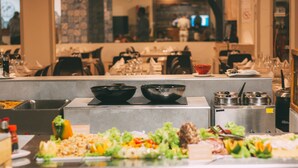 A buffet setup with various food items and kitchen equipment. - Halos Casa Resort (Sal)