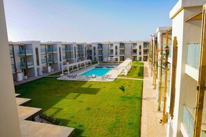 Relax by the pool in our central courtyard, surrounded by hotel rooms with balconies.