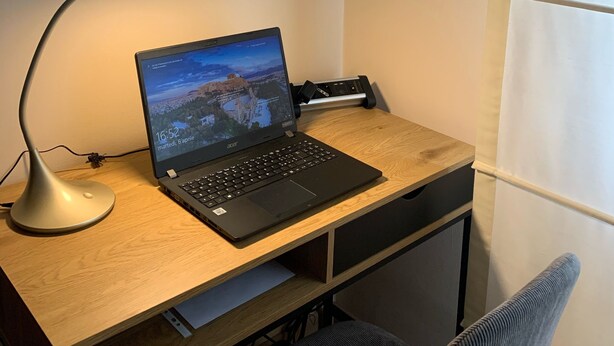 A laptop on a wooden desk with a monitor displaying a landscape, a desk lamp, and a framed picture of a building on the wall. - VIOLINS AND MUSIC APARTMENT IN DOWNTOWN CREMONA - AT ANTONELLA'S HOUSE - (Cremona)