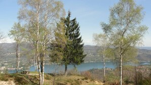 A scenic overlook with a view of a lake and surrounding hills.