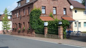 A traditional brick building with a sloped roof, multiple windows, and a small satellite dish. - Pension  Zum Stern (Freudenberg)