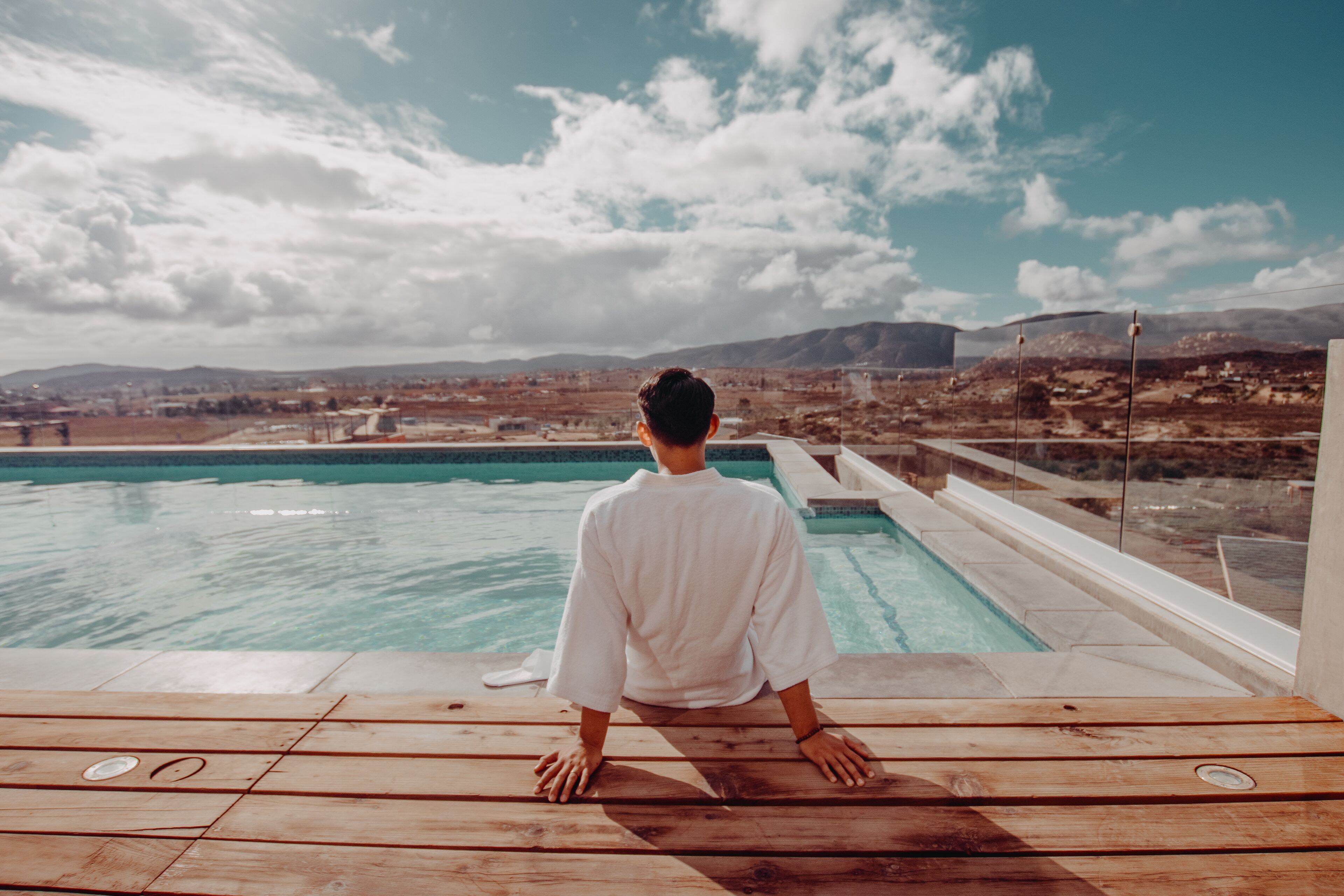 Una piscina al aire libre, sillones reclinables de piscina