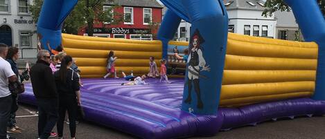 An inflatable play area with a pirate theme, including a large arch with the words "Pirates Adventure".