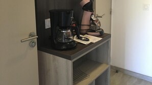 A kitchenette with a coffee maker, a kettle, and a microwave. There is a door with a towel rack above it. - 2 rooms St Raphaël from Saturday 12/08 > 19/08/2023: €795 per week (Saint-Raphaël)