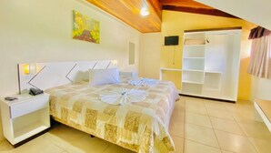 A bedroom with a bed, nightstand, and a wardrobe. - Zermatt Hotel (Gramado)