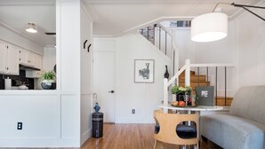 A modern living space with a kitchen, dining area, and staircase. - Luxuriously Restored Loft in Old Town Alexandria (Alexandria)