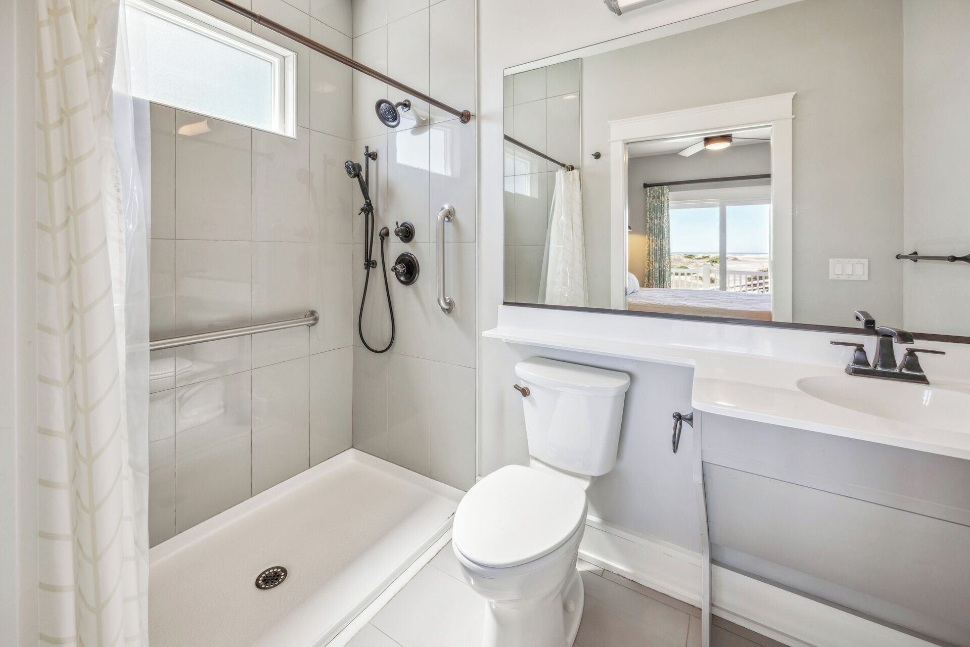 Ein modernes Badezimmer mit barrierefreier Dusche, Toilette und Waschbecken.