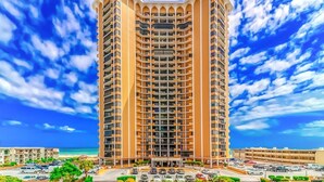 A tall, multi-story hotel with a central courtyard and balconies.
