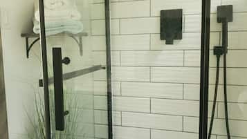 Shower, hair dryer, soap, toilet paper