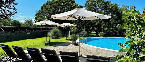 Seasonal outdoor pool, pool umbrellas, pool loungers