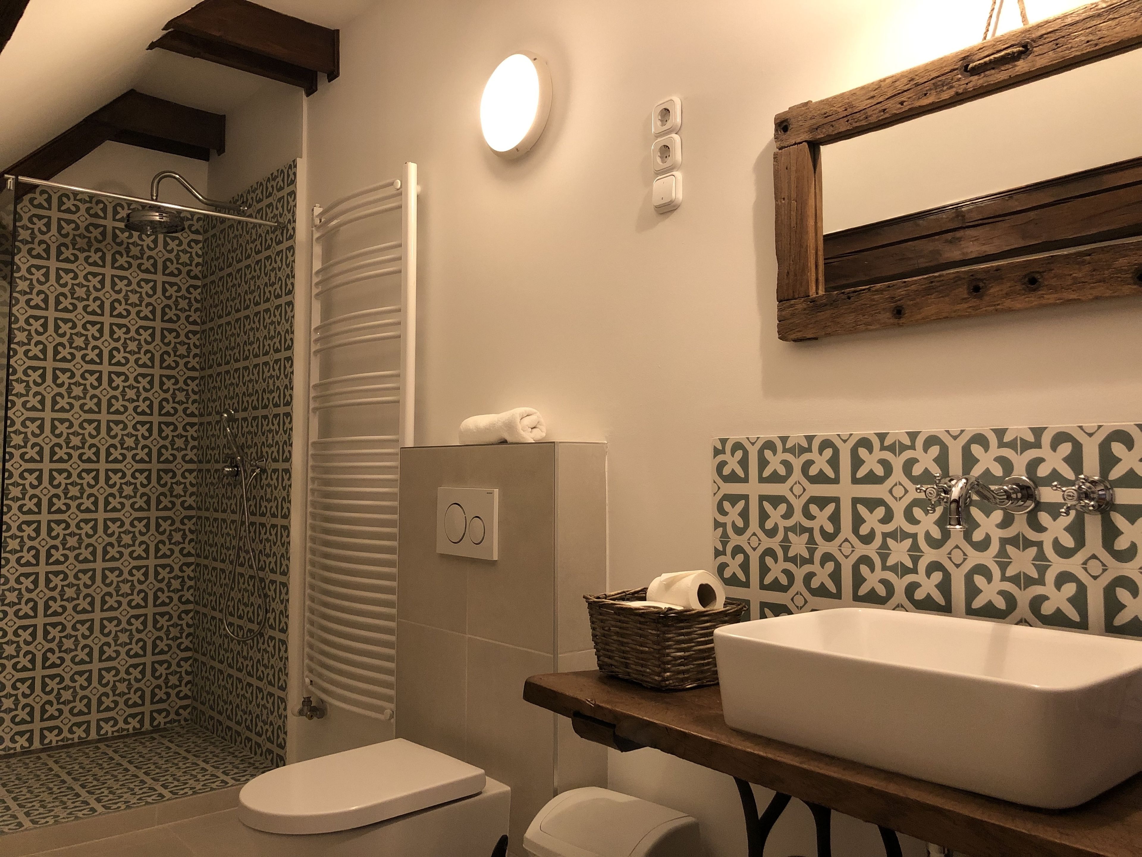 A bathroom with a shower, toilet, and sink.