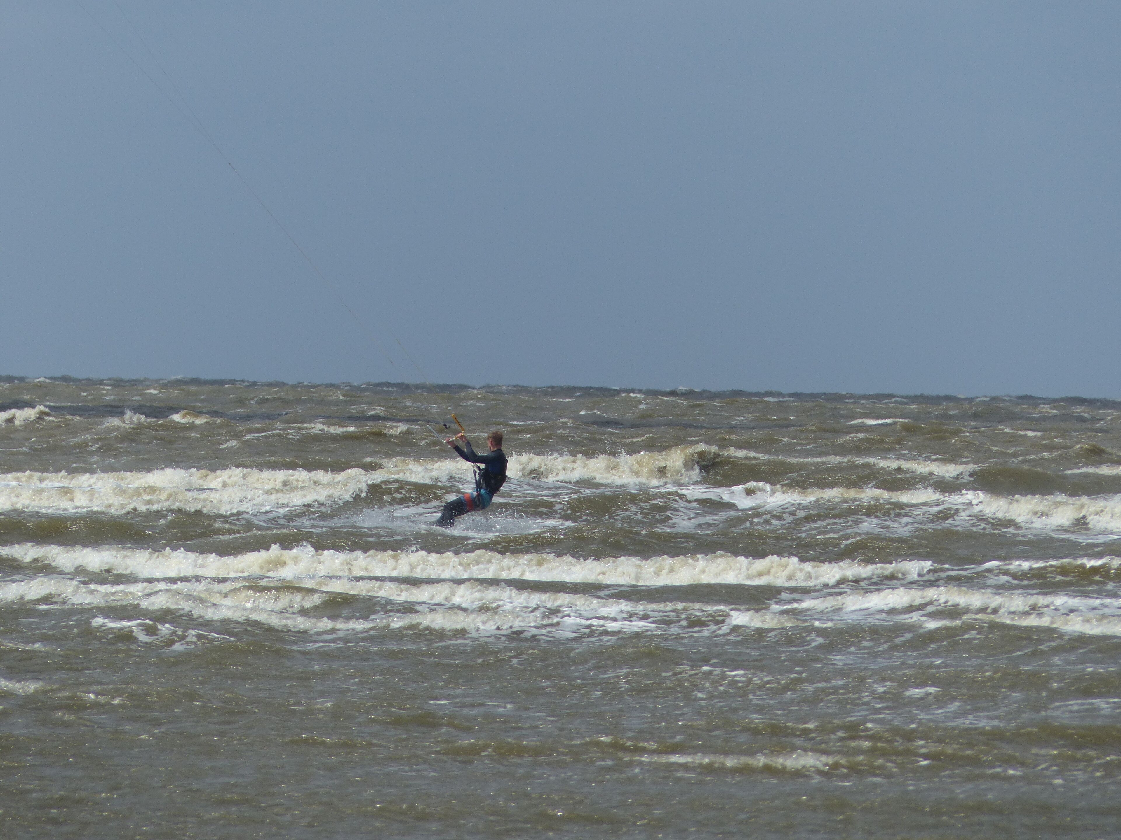 A person windsurfing in a large body of water.