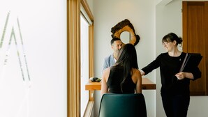 A room with a large window, a wooden desk, and a decorative wall piece. - Pluvio Restaurant and Rooms (Ucluelet)