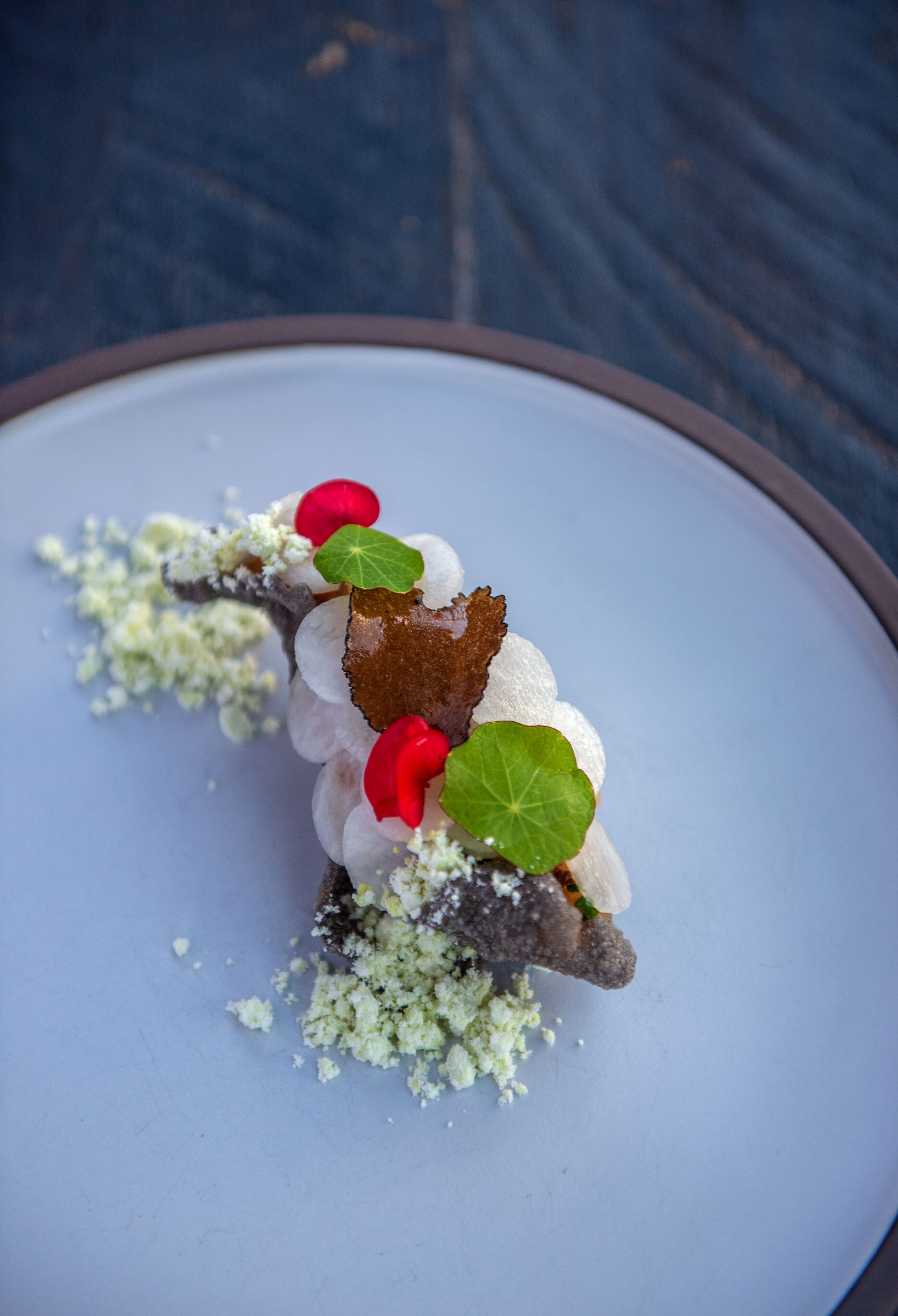 A dessert on a plate with a blue background.