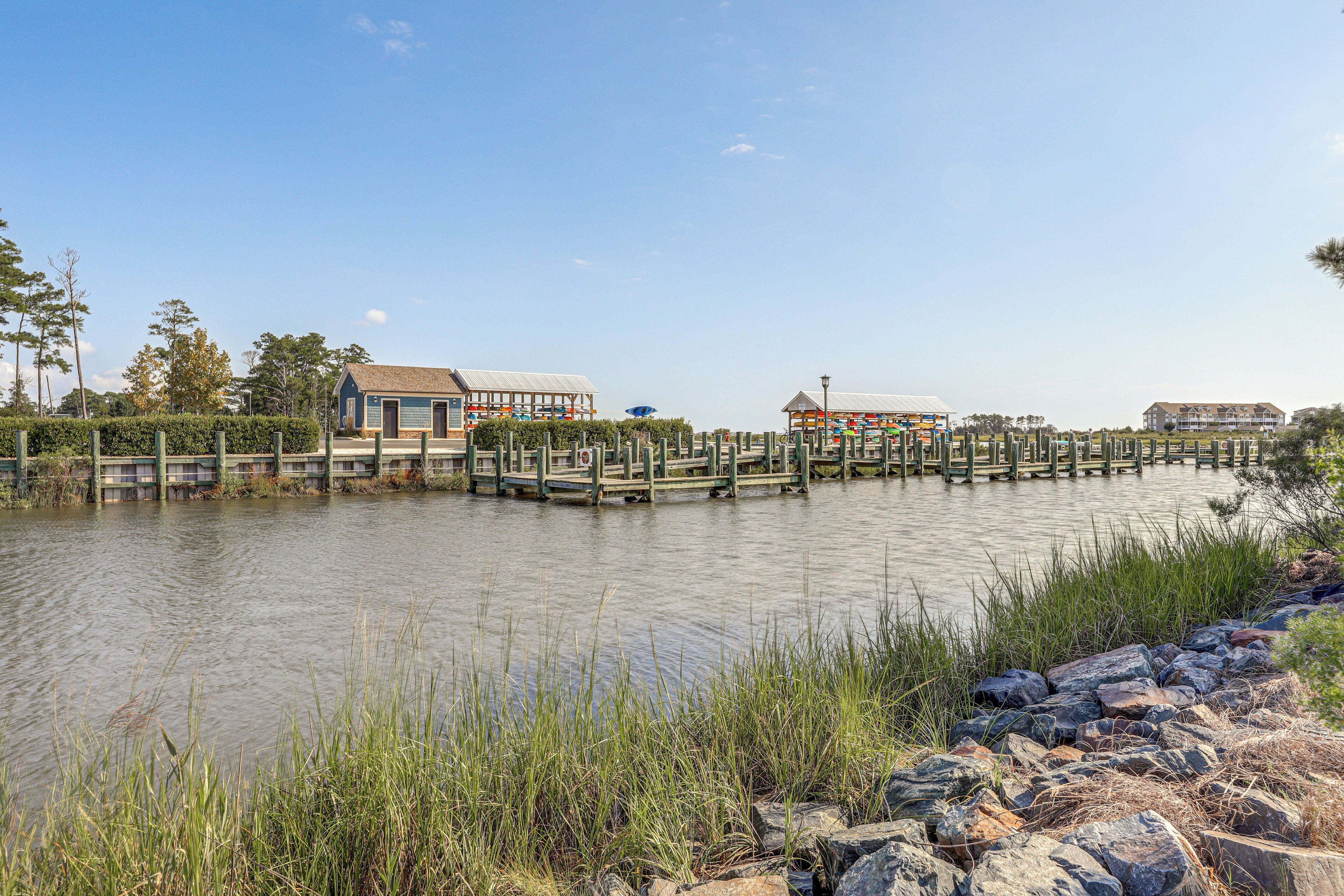 A riverside wooden pier with a building and a gazebo.