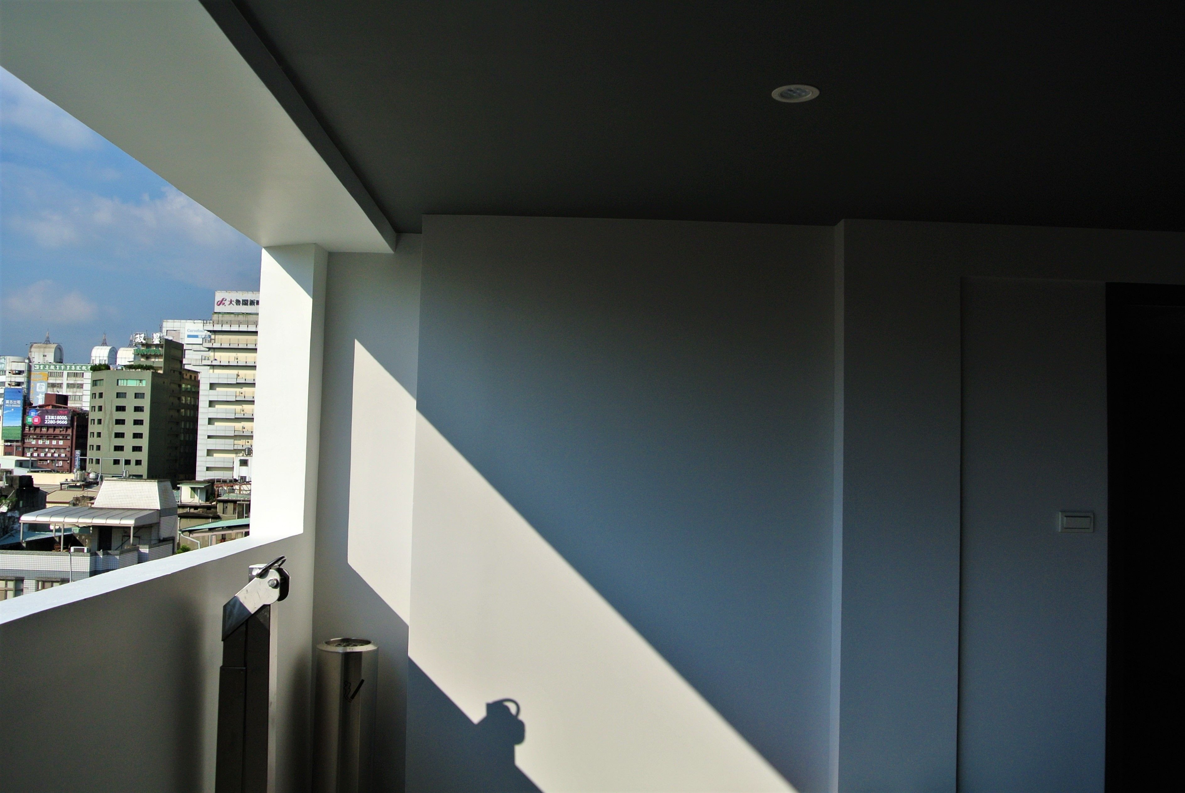 A room with a view of a cityscape, a window, and a door.